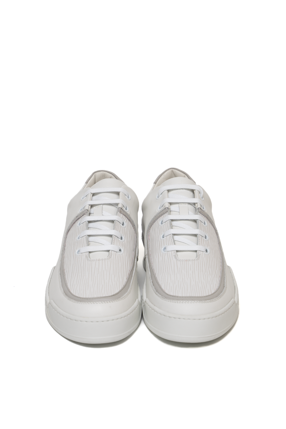 Front view of the Vaarora Aaron Low Top handmade premium leather sneaker in white featuring a ribbed texture and grey piping