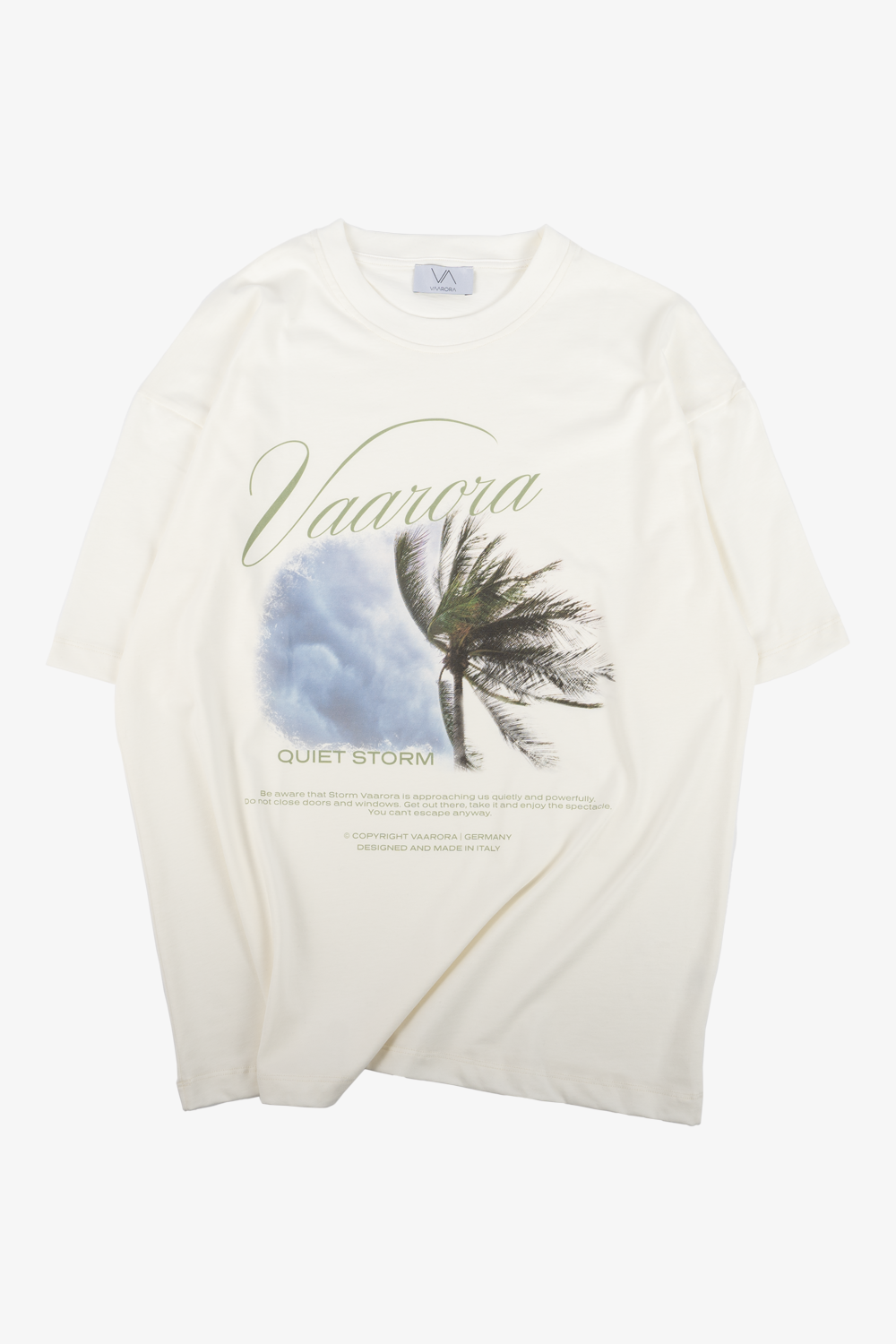 Front view of the cream Vaarora Quiet Storm Palm Tee featuring an evocative storm graphic, cursive typography, and text