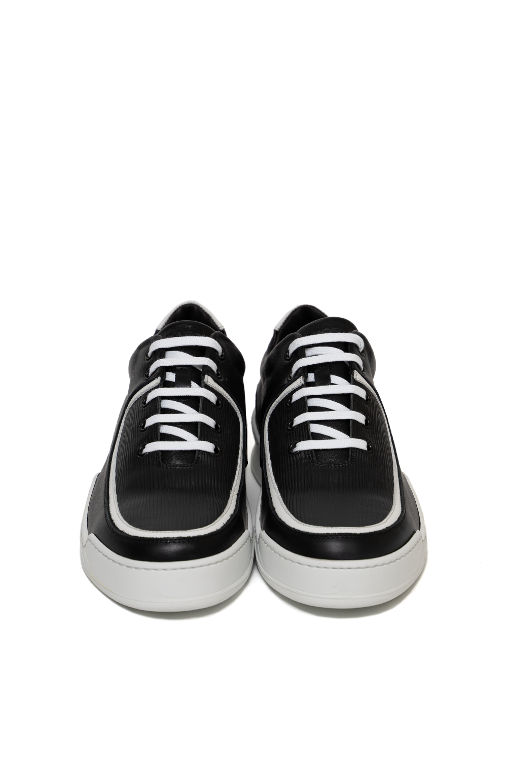 Front view of the Vaarora Aaron Low Top handmade premium leather sneaker in black featuring a ribbed texture, white piping, and white laces