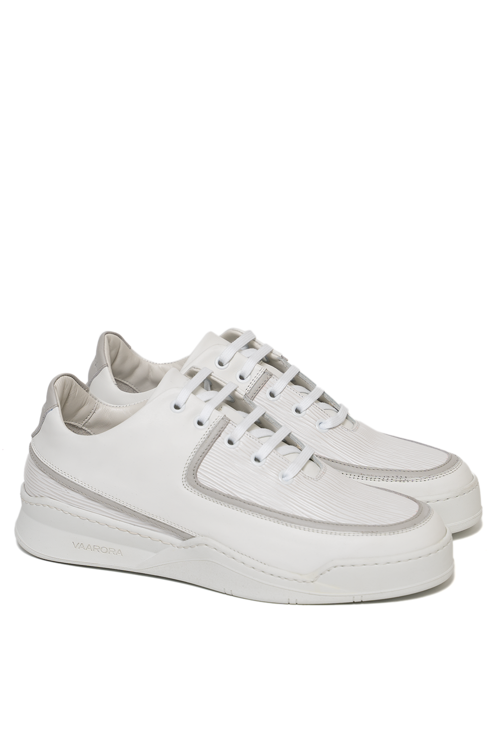 Side view of the Vaarora Aaron Low Top luxury sneaker showcasing the smooth and textured white leather, subtle grey accents, and heavy-weight rubber sole